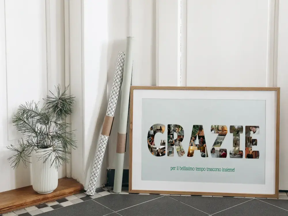 Poster con collage di foto a forma di lettere, in cornice di legno a terra accanto a una pianta, come regalo di anniversario