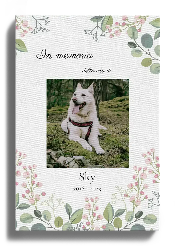 Tela in ricordo di un cane con foto, nome e date di nascita e morte, decorata con fiori e foglie verdi